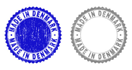 Grunge MADE IN DENMARK stamp seals isolated on a white background. Rosette seals with grunge texture in blue and gray colors. Vector rubber watermark of MADE IN DENMARK tag inside round rosette.