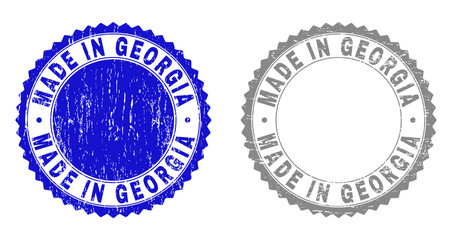 Grunge MADE IN GEORGIA stamp seals isolated on a white background. Rosette seals with distress texture in blue and grey colors.