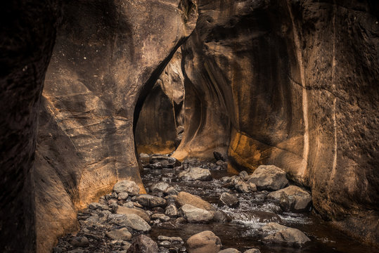 An eroded cave/tavern carved out by a stream in the Tugela Gorge hike on the Amphitheatre Mountain, Drakensberg, South Africa