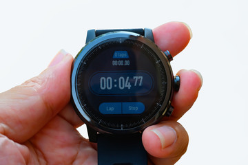 Close up digital stop watch in the hand on white background use for sport concept and technology background
