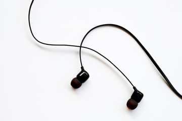Black earphones on white background or earphones isolated use for mobile phone accessory background