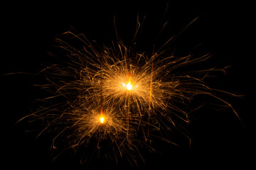 Bengal fire. New year sparkler candle on black background