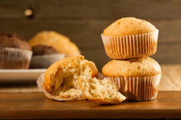 Vanilla cupcake, homemade pastry on wooden background, close-up