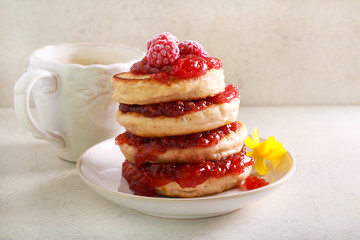 Pile of pancakes with raspberry jam