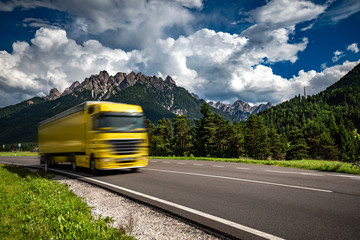 Fuel truck rushes down the highway in the background the Alps. Truck Car in motion blur.