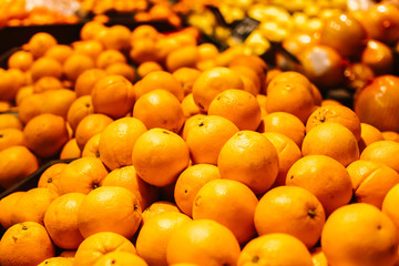 Orange on a display in a supermarket in bulk