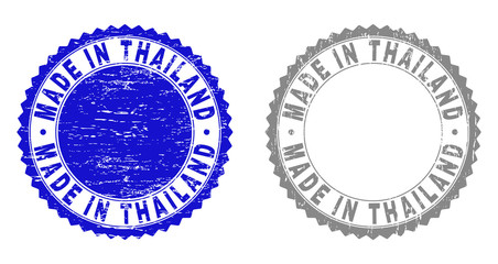 Grunge MADE IN THAILAND stamp seals isolated on a white background. Rosette seals with grunge texture in blue and grey colors. Vector rubber stamp imprint of MADE IN THAILAND tag inside round rosette.