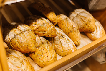 Bread Shop. Fresh tasty bread are on the shelves. Variety of delicious breads displayed on shelves in bakery