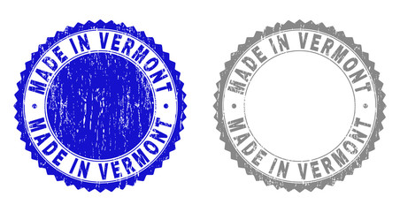 Grunge MADE IN VERMONT stamp seals isolated on a white background. Rosette seals with distress texture in blue and grey colors.