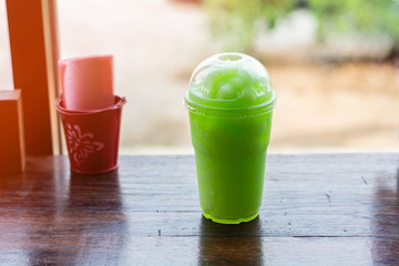 Fresh kiwi juice soda on wood table