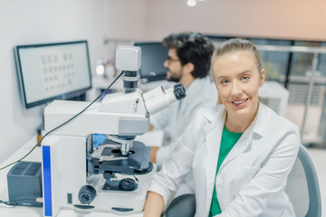 Young scientists in white uniform working in laboratory