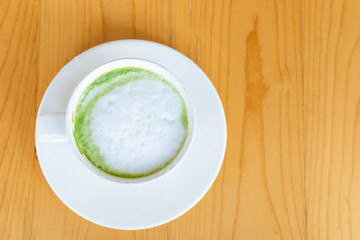 hot Matcha green tea latte beverage in table