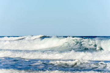 Ocean waves and blue sky background
