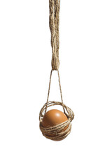 Single brown egg with hanged on a rope. Hanging Easter egg isolated on white background