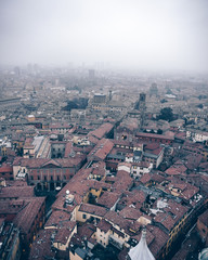 Aerial view of Bologna's city center from the top of the Due Torri in foggy weather