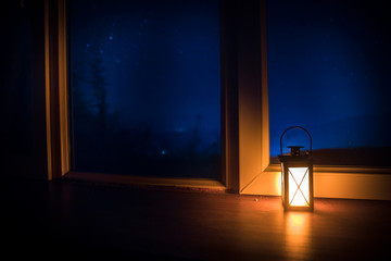 Night scene of stars seen through the window from dark room. Night sky inside dark room. Long exposure shot