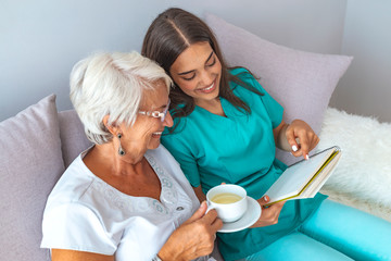 Obraz na płótnie Canvas Helpful volunteer taking care of senior lady at healthcare home
