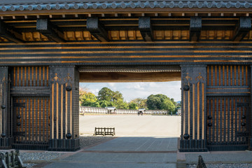 Brown vintage abstract background with detail of Japanese traditional wooden gates with metal...