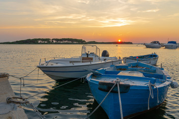 Fototapeta premium The boats and the sunset in Porto Cesario, Puglia, Italy