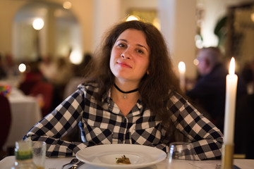 Love, relationship and date concept - Happy young woman over candlelight during romantic dinner at restaurant