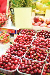 cherries in boxes on the market counter
