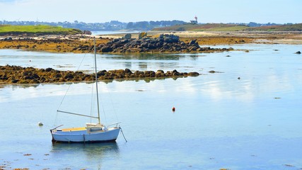 Yacht during ocean low tide in Lilia, Brittany, France