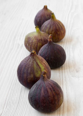 Fresh figs on a white wooden background, low angle view.