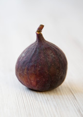 Fresh fig on a white wooden background, side view. Closeup.