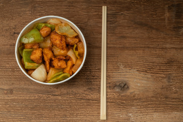 sweet and sour chicken on a wooden table