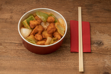 sweet and sour chicken on a wooden table