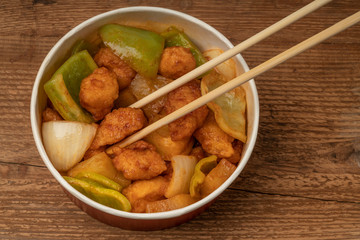 sweet and sour chicken on a wooden table