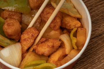 sweet and sour chicken on a wooden table