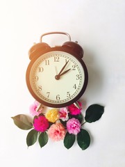 vintage alarm clock and flowers