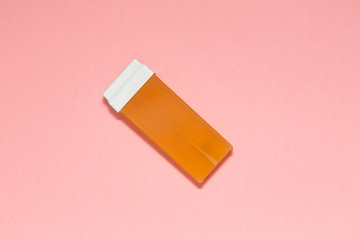 Beauty, depilation and hair removal concept - wax, spatula, epilator and safety razor on pink background. Top view.