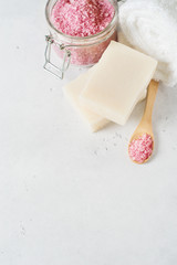 Spa and body care concept with himalayan salt, soap and towel on white background