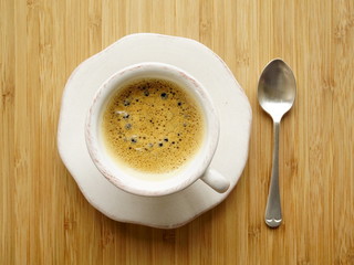 Coffee espresso, top view, wooden table, silver teaspoon