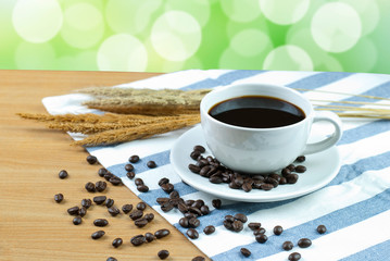 cup of coffee and beans on wooden table