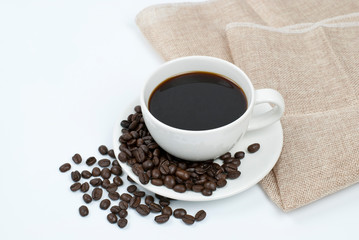 White coffee mug and coffee bean