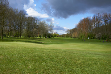 Landscape of a beautiful golf course with greens and holes and bunkers