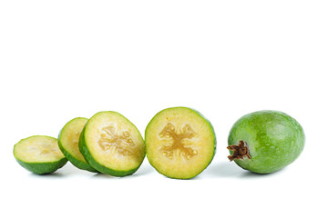 Whole and sliced feijoa fruits isolated on white background
