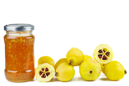 Glass jar with maules quince (Chaenomeles japonica) jam isolated on white background