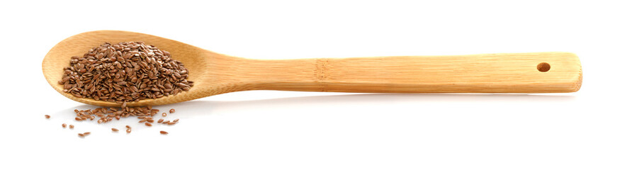Flax seed. Linen in wooden spoon on white isolated background.