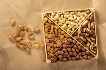 Assorted nuts. 4 types of nuts. Place for text. wrapping paper. Healthy natural food.