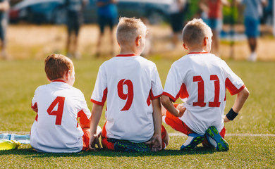 Young Soccer Boys During Football Match. Boys Kicking Football on the Sports Field