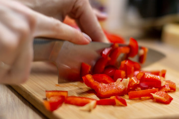 Woman hands cutting vegetables in the kitchen