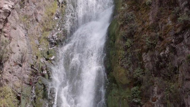 Slow Motion: Panning Down Steep Waterfall to Pool at the Bottom