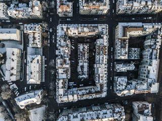 Aerial view of urban block buildings in top view. Pattern of architecture with roofs and streets.
