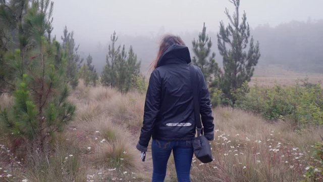 Slow Motion: Young Woman on Trail Winking at Camera