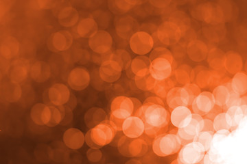 White bokeh on an orange background