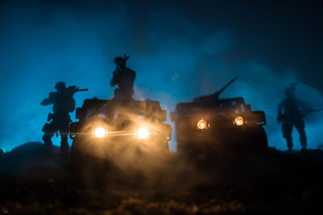War Concept. Military silhouettes fighting scene on war fog sky background, Fighting silhouettes Below Cloudy Skyline At night. Battle scene. Army vehicle with soldiers. army